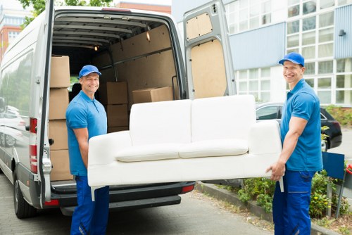 Professional piano removal team handling an upright piano in Kingston Upon Thames