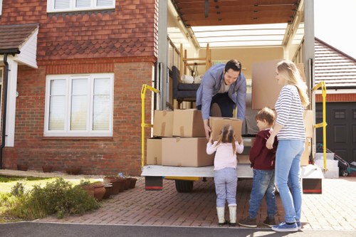 Local house removals support in Kingston Upon Thames with moving van and packed boxes