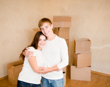 Packed household boxes and furniture prepared for loading