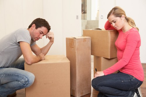 Removalists handling furniture in a Kingston upon Thames property